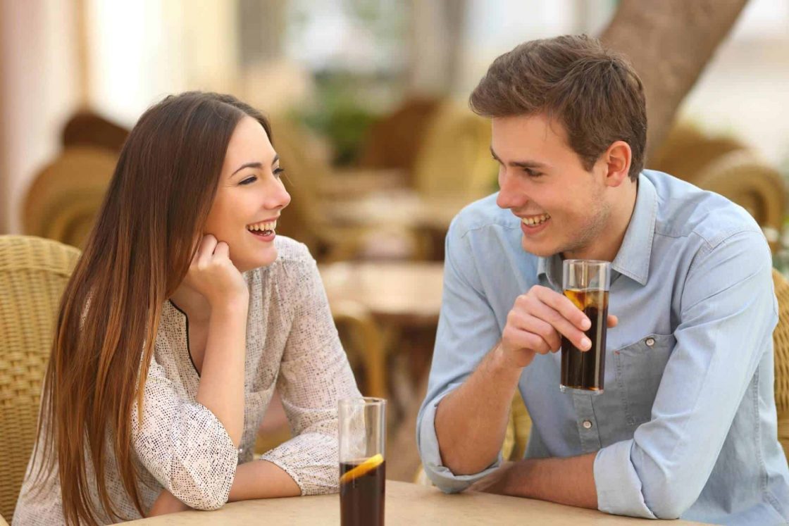 một nguwoif đàn ông và một người phụ nữ đang vui vẻ nói chuyện với nhau trong một quán cà phê - hình ảnh minh họa cho mẫu câu và các từ vựng tiếng Anh về cách đưa ra ý kiến